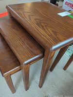 Top view of three stacked oak nesting tables