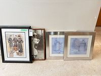 Group shot showing all four framed artworks lined against wall