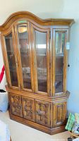 Full view of Drexel Heritage china cabinet showing two-piece structure and medium brown finish