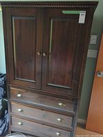 Full view of armoire showing doors, drawers and hardware