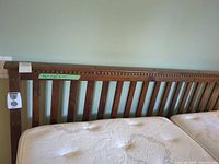 Headboard full view showing vertical slats and dentil crown rail