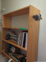 Front view of pine bookcase showing shelves and contents for scale