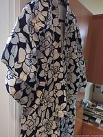 Front view of navy floral kimono robe on hanger