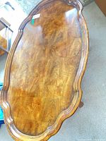 Top view of oval coffee table showing veneer pattern and finish