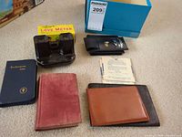 Group shot showing all items including viewer, Magic Love Meter box, books, wallets, glasses case