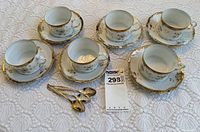 Full set of 6 cups, 6 saucers, 3 teaspoons on lace tablecloth