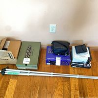 Overall lot showing tripod and boxed items on floor