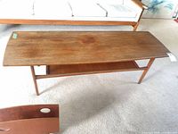 Top view of teak coffee table showing surface wear
