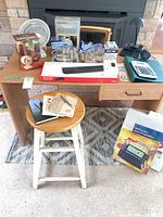 Overall lot showing desk, stool, boxed keyboard, mailstation bag, fan, coin wrappers, camera