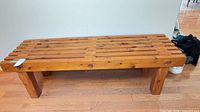 Full front view of slatted pine bench table