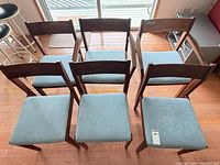 Top view of six chairs showing seat upholstery and arrangement
