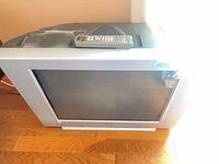 Front view of Sony CRT TV with remote on top