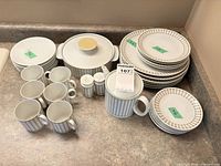 Full set laid out showing plates, cups, serving pieces and shakers