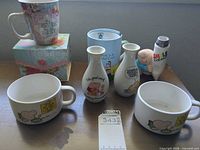 Full lot showing bowls, vases, mugs, figurine and gift box