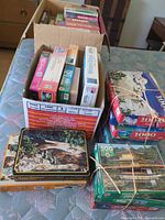Grouped view of all boxed puzzles on table and in carton