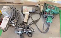 Group shot of all four tools laid out showing cords, air fitting and overall wear