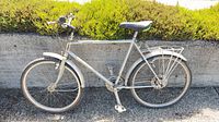 Full side view of silver Maruishi commuter bicycle with rack and fenders