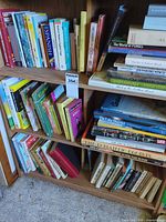 Books on two shelves showing mix of hardcovers, paperbacks and spiral bound volumes