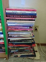 Stack of approximately 30 royal family and Canadian photography books on floor