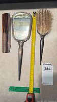 Full view of mirror, brush, comb with measuring tape