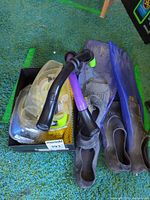 Fins, mask, snorkel tubes and mesh bag grouped together
