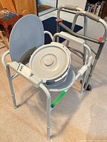 Commode chair with bucket and folding two-wheeled walker