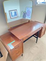 Overall view of vanity showing mirror, pull-out surface, drawers