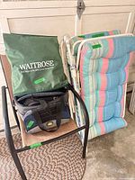 Overall lot showing chair, cushions, bags, umbrella