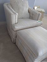 Barrel chair with ottoman and pillow showing overall look and fabric pattern