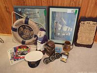 Group shot of entire lot showing prints, life ring, sailor figure, magazines, cap, diving helmet, stein, accessories