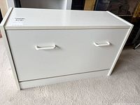 Front view of white laminate shoe cabinet