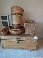 wooden chest with assorted wicker baskets stacked on top