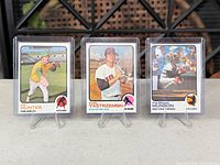 Front view of all three sleeved cards on stands