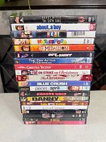 Stack of 18 DVD cases showing titles from The Sixth Sense to 8 Mile