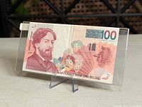 Obverse view of entire 100 francs banknote in holder