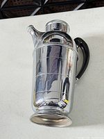 Full view of Farber Bros silver-plated cocktail shaker with Bakelite handle