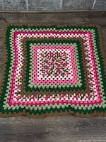 Full view of square crocheted afghan laid flat