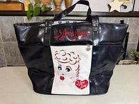 Front view showing graphic, logo, handles