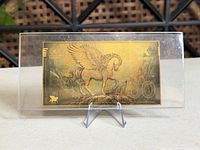 Full view of gold-plated Kinesis Aurum 50 foil note in acrylic sleeve on stand