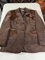 Full view of brown corduroy blazer laid flat