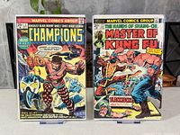 Front covers of both comic books in bags and boards