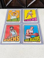 Group shot of all four sleeved Topps basketball cards