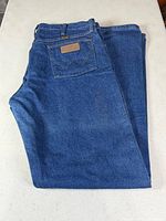 Wrangler blue jeans folded showing back pocket and leather patch