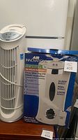 Boxed Air Innovations humidifier next to tower fan