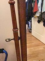 Close view of side post, wood grain, tilt screw hardware