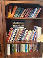 Overall view of two shelves filled with books and study materials