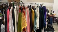 Full rack showing majority of assorted coats, jackets, blazers in various colors