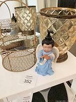 Amber glass vase, metal wire basket, angel soap dispenser grouped together