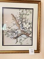 Full view of framed artwork showing birds, blossoms, frame style