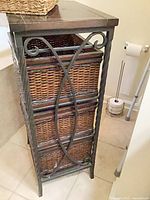 Full view of cabinet showing metal frame and wicker drawers
